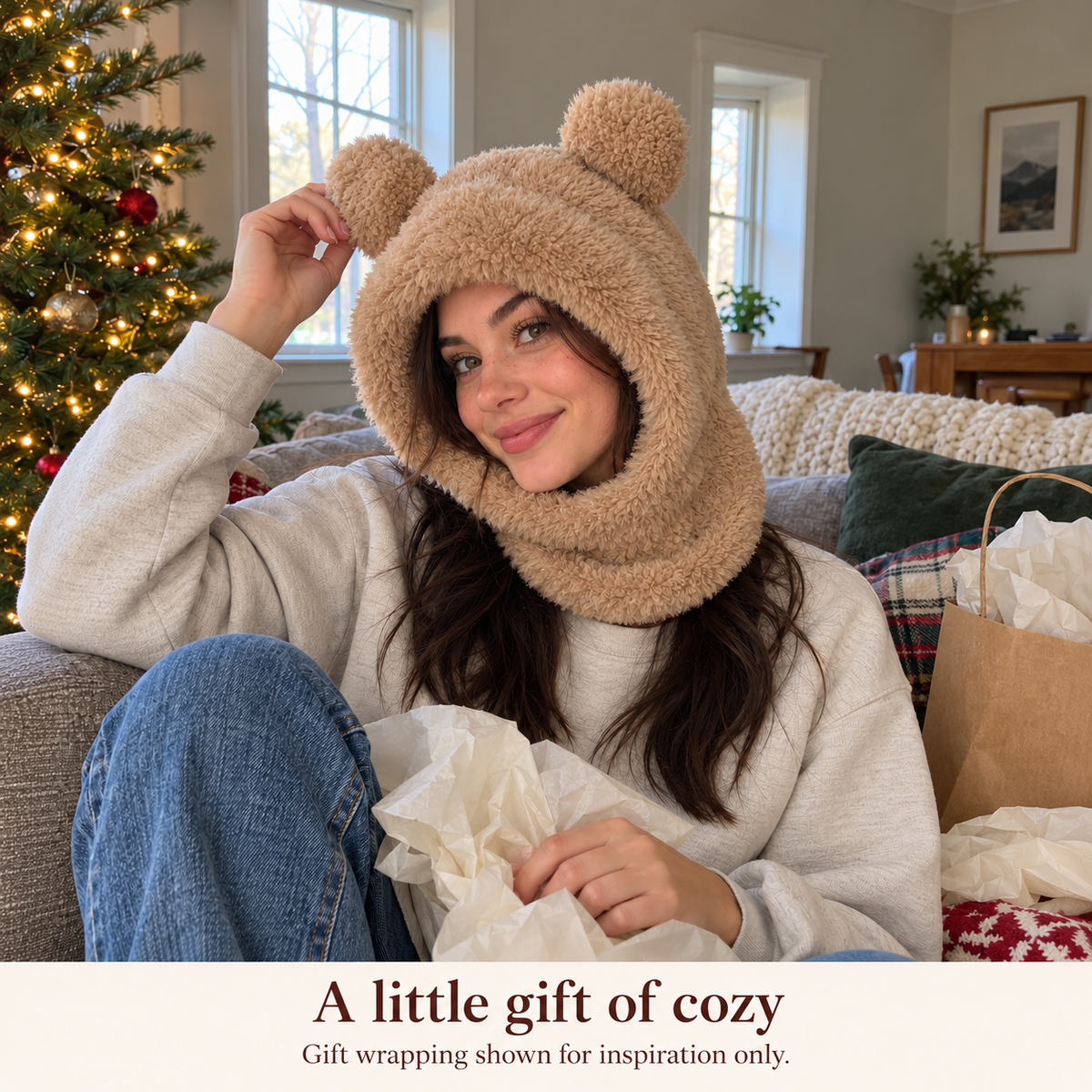 Woman trying on the bear hood after unwrapping a gift; gift wrapping shown for inspiration only